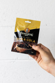 Hand holding packet of beef jerky up in the air
