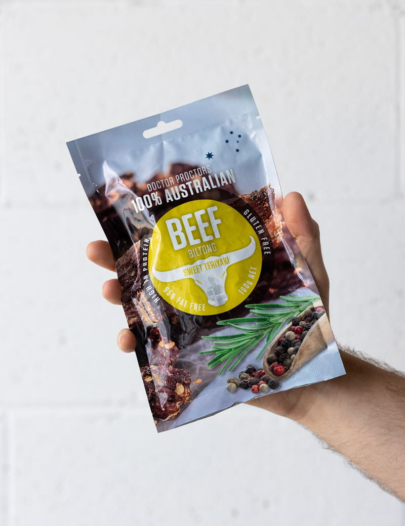 Hand holding a pouch of biltong