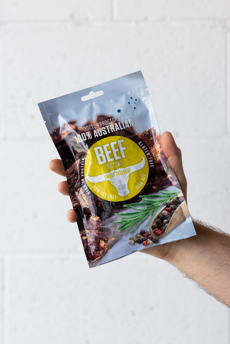 Hand holding a pouch of biltong