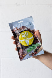 Hand holding a pouch of biltong