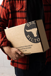 Man holding box of biltong 
